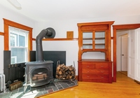 Second floor wood stove; skillfully stripped woodwork